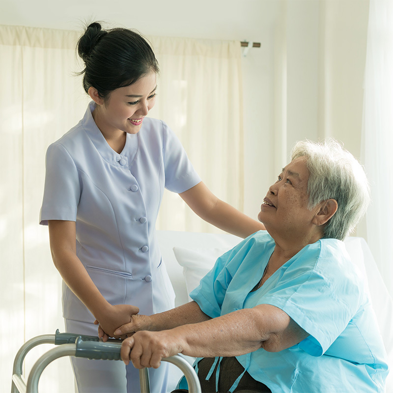 Hospice nurse putting her hand gently on a patient's shoulder.